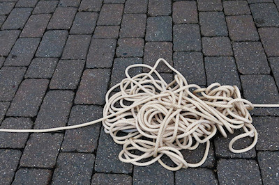 Tangled rope lying on the ground.