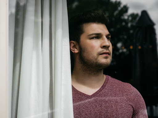 Man gazing out of window